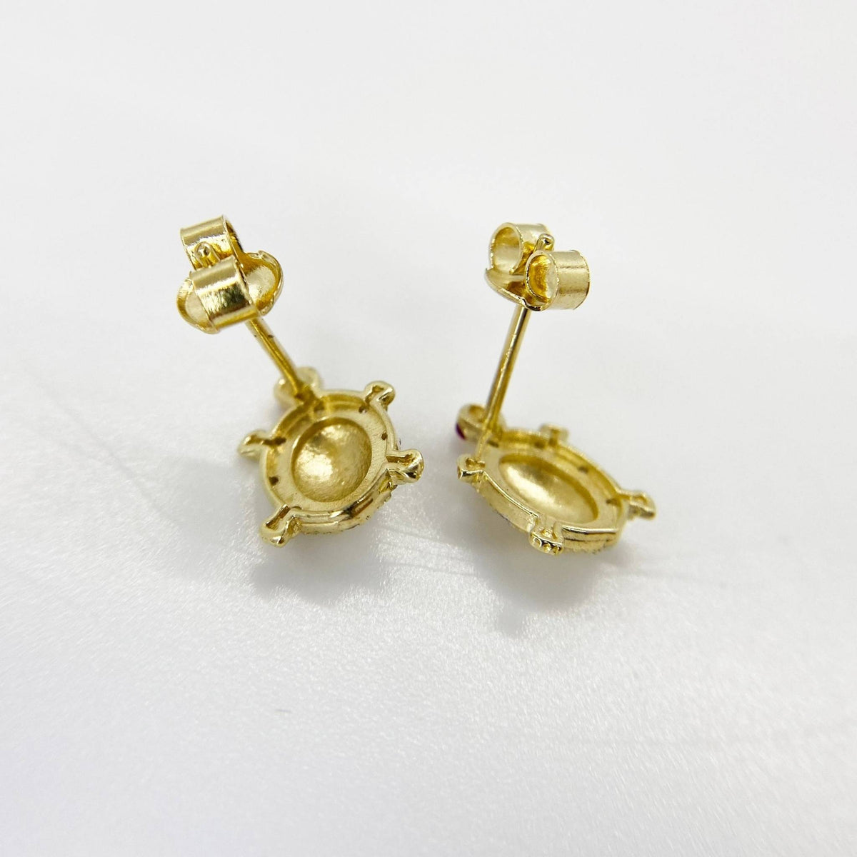 Reverse side of gold turtle stud earrings with secure push-back closures.