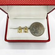 10k gold turtle stud earrings with cubic zirconia and a U.S. quarter for scale.
