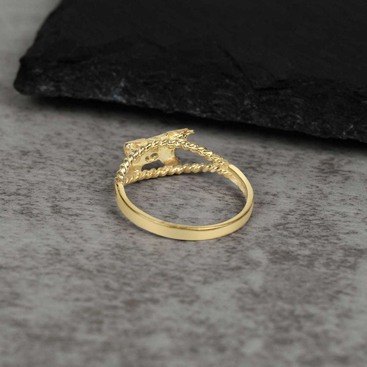 Back view of 10k gold mini Uzi ring showing the inner band on stone.