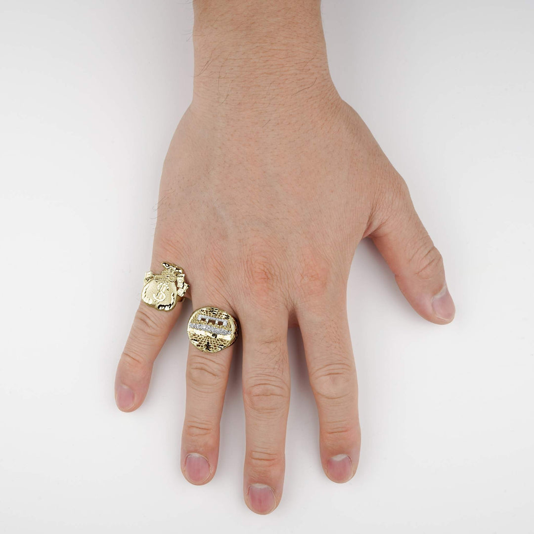 Hand wearing a 10k gold money loot bag ring and another statement ring.