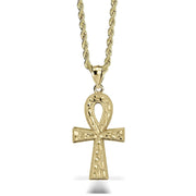 A gold Ankh pendant necklace on a twisted gold chain against a white background.