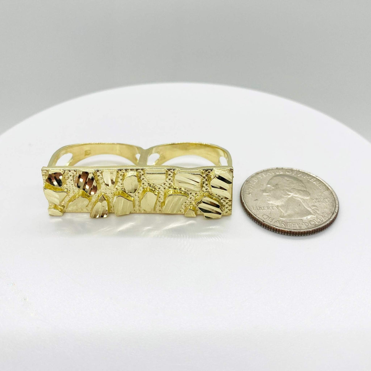 10k Gold Nugget Classic Two Finger Ring next to a quarter on a white surface