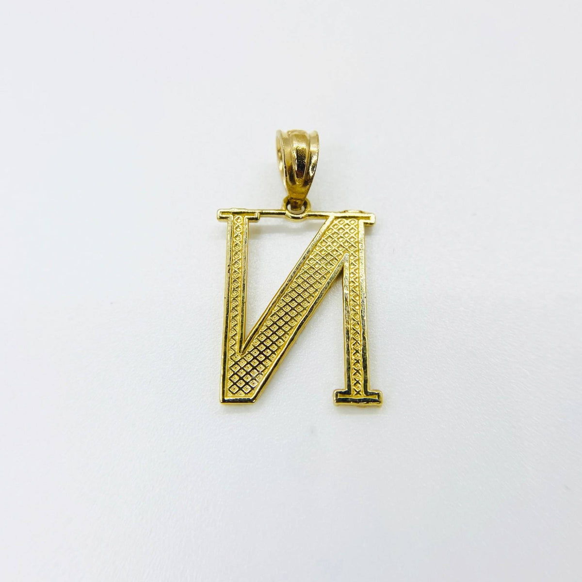 Back view of a 10k yellow gold nugget initial N pendant on white background