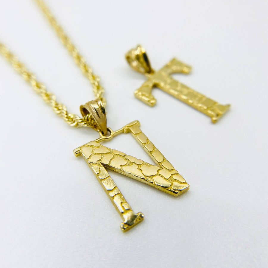 10k yellow gold nugget initial N pendant necklace with T charm in background