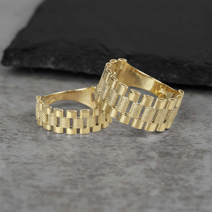Two Nolters 10k gold presidential-style Rollie band rings on a dark background.