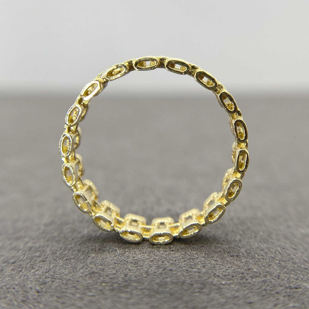 10k Gold Pattern Rollie Eternity Band ring back view on a gray background