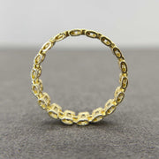 10k Gold Pattern Rollie Eternity Band ring back view on a gray background