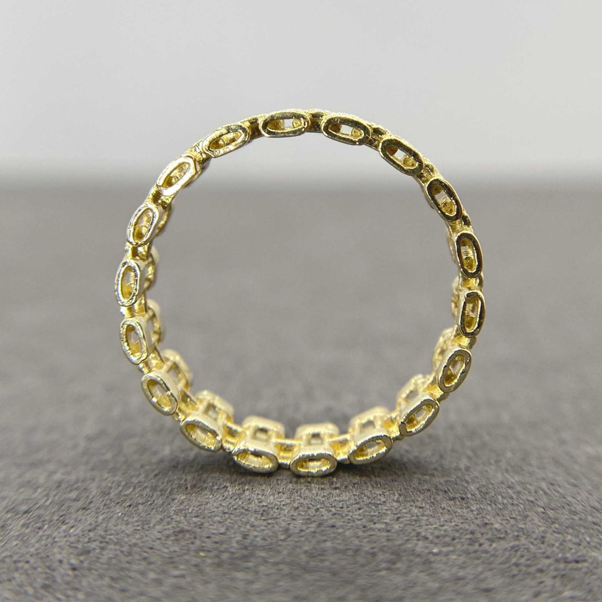10k Gold Pattern Rollie Eternity Band ring back view on a gray background