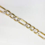 Detailed view of 10k yellow gold Figaro chain with clear stone link accents.