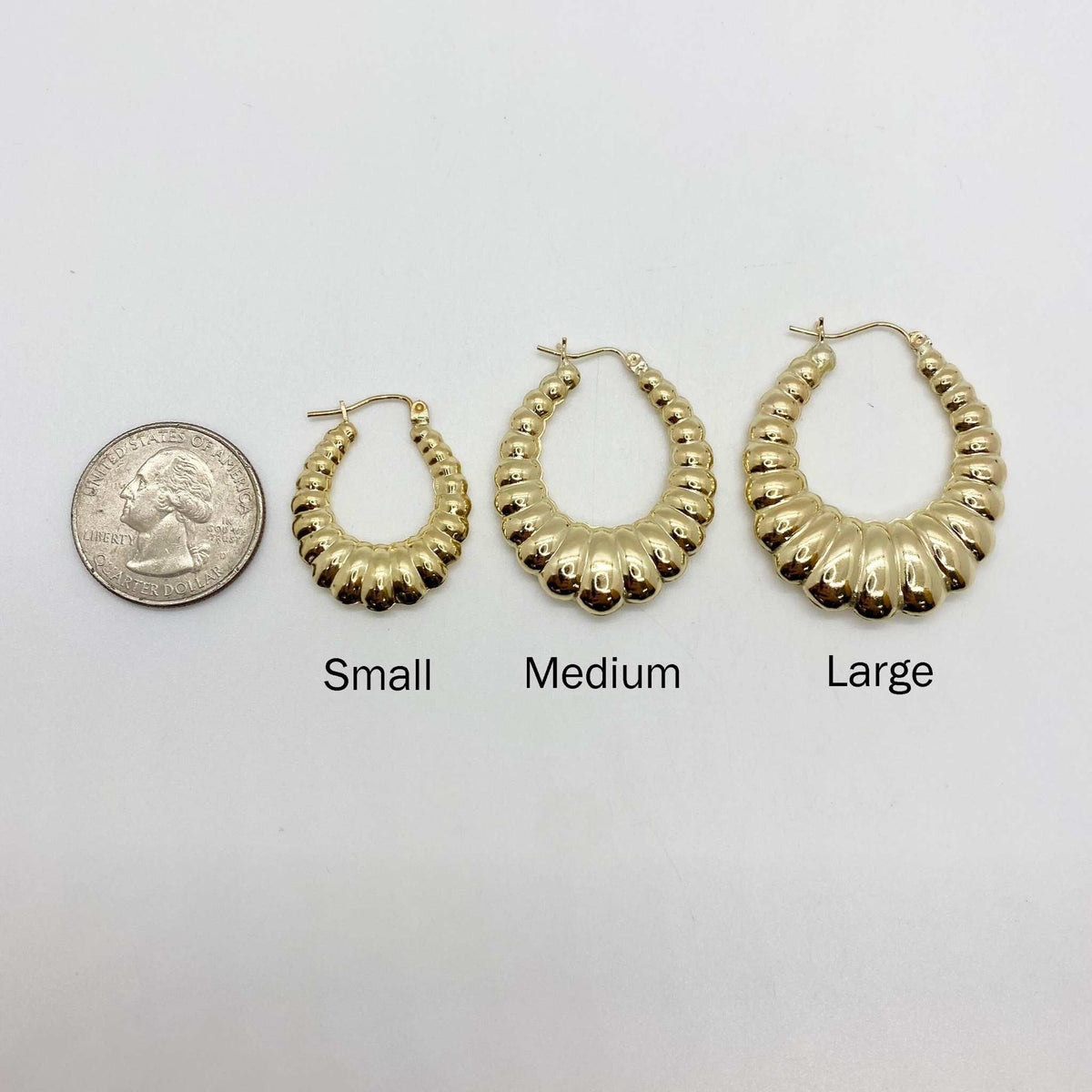 Size comparison of Small, Medium, and Large 10k yellow gold shrimp hoop earrings.