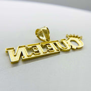 Reverse side of 10k diamond-cut yellow gold "QUEEN" crown pendant showing hollowed back construction.
