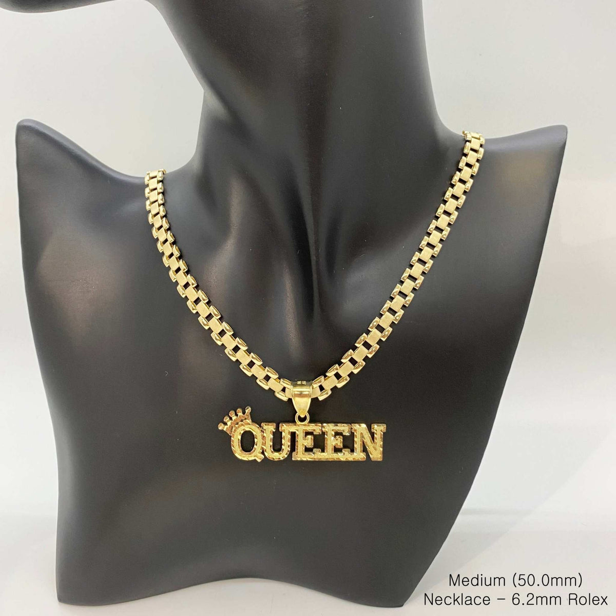 Medium gold "QUEEN" crown pendant necklace with 6.2mm Rolex chain displayed on a jewelry mannequin.