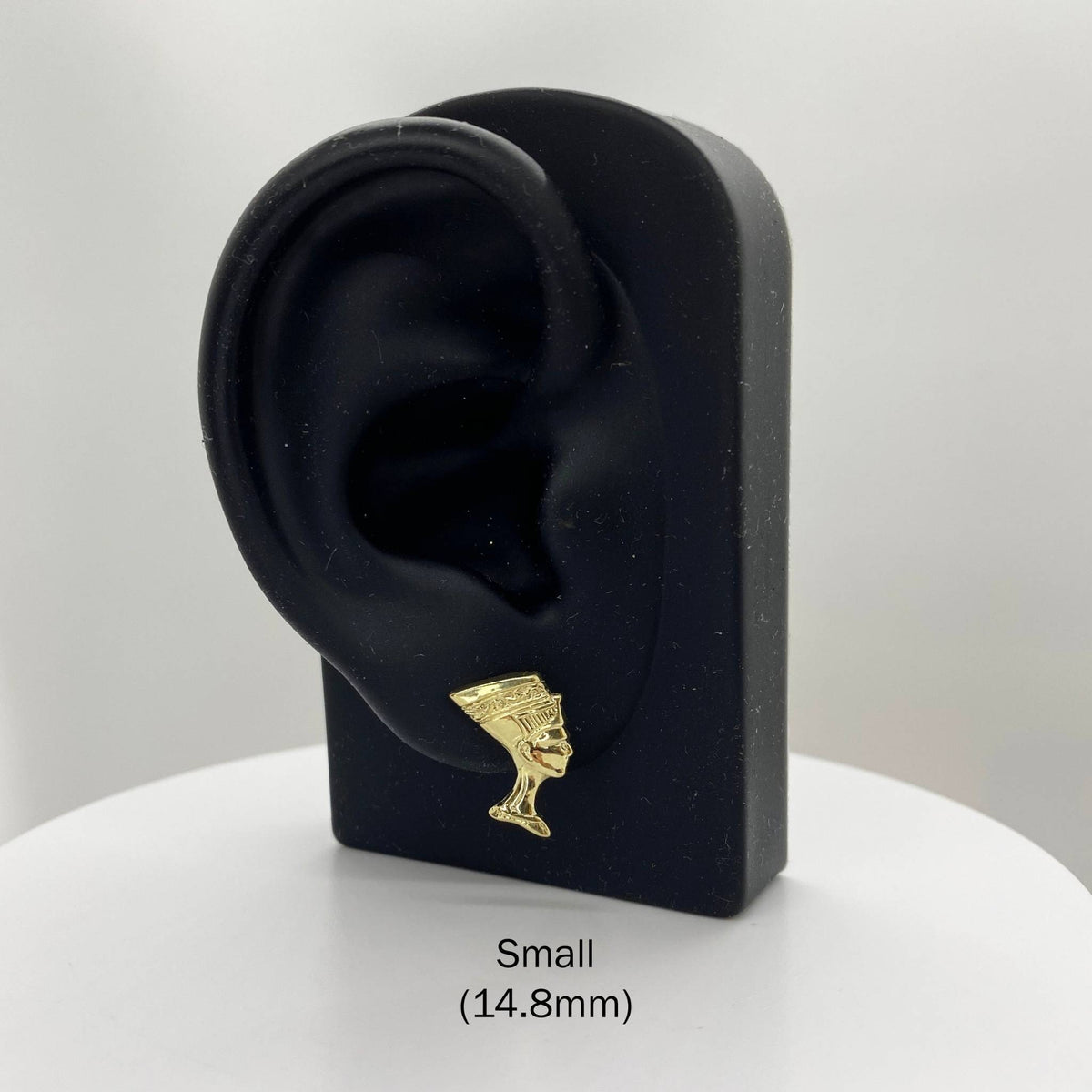 Small 14.8mm 10k gold Queen Nefertiti stud earring on a black display stand.