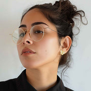 Female model wearing 10k gold Rav butterfly stud earrings with clear CZ stones.