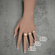 Hand modeling three 10k gold heart rings displaying size and dimension labels.