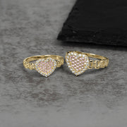 Two 10k gold heart-shaped rings with pink and white cubic zirconia stones.