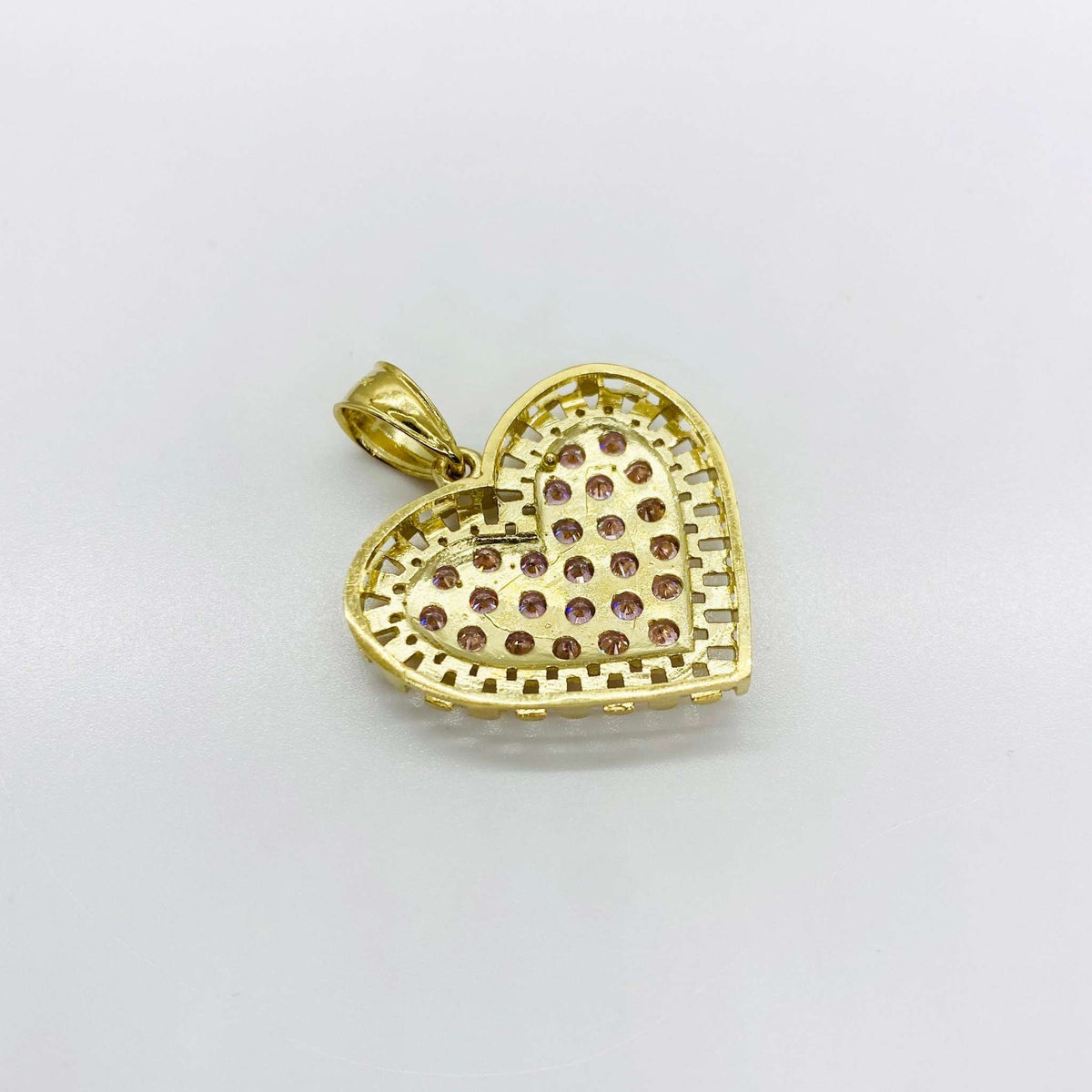 Back view of gold heart pendant featuring a textured openwork design and pink stones.
