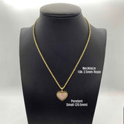 Open hand displaying small, medium, and large gold heart pendants with pink stones.