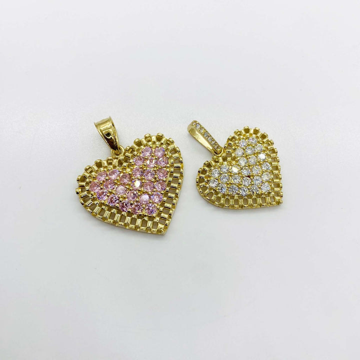 Two gold rollie-style heart pendants, one with pink stones and one with white stones.