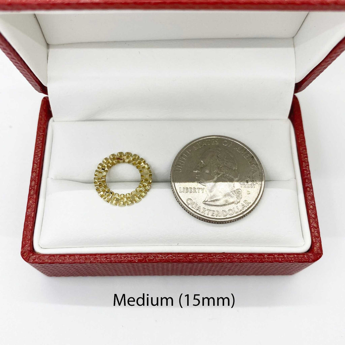 Medium 15mm 10k gold round stud earring next to a U.S. quarter for scale.
