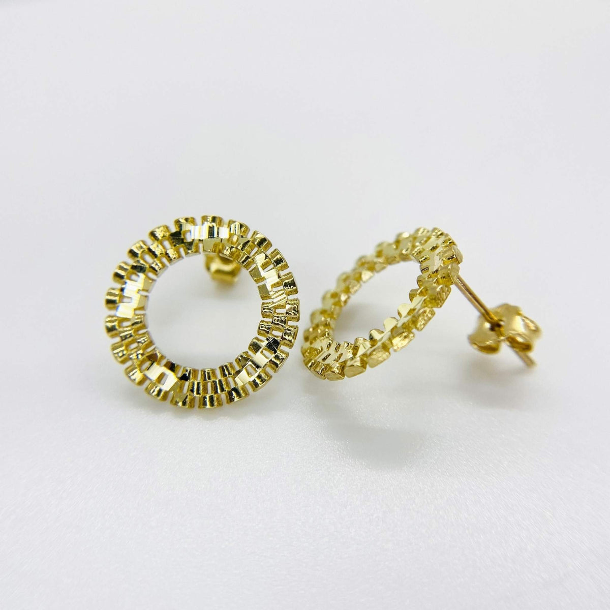 Pair of 10k yellow gold round stud earrings with a textured, beaded edge design.
