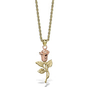 A gold and rose gold rose pendant necklace on a twisted gold chain,