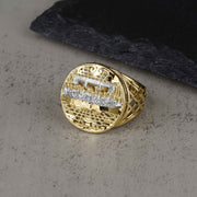 Round 10k gold two-tone Last Supper ring displayed on a gray surface.