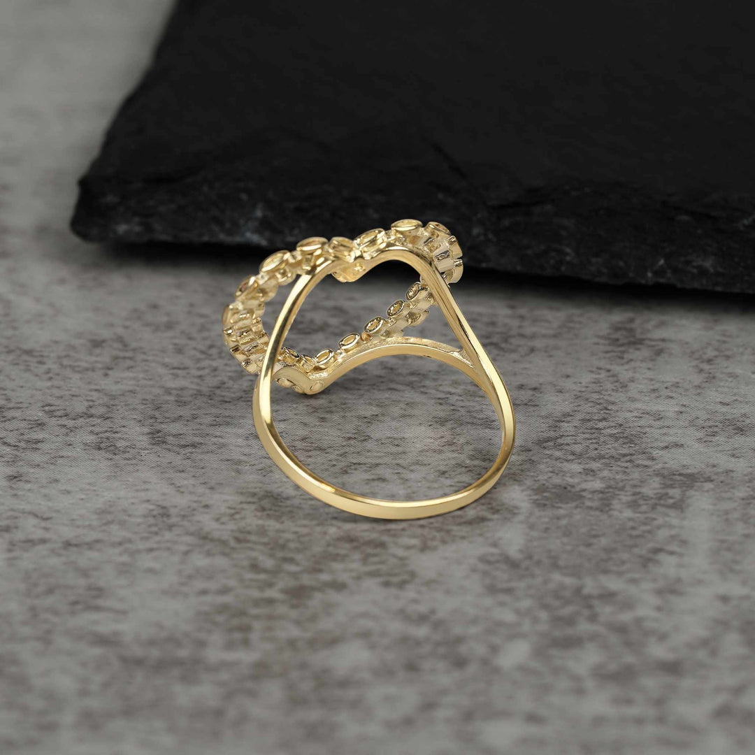 Back view of a 10k gold heart ring showing the smooth, polished inner band.