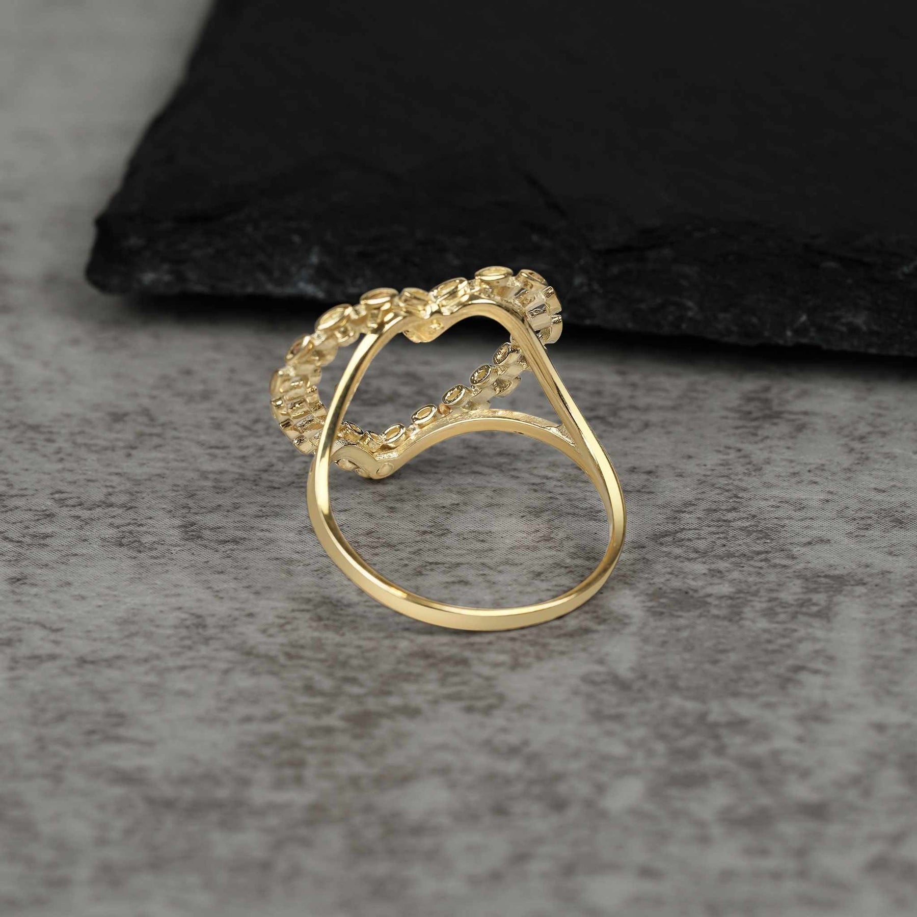 Back view of a 10k gold heart ring showing the smooth, polished inner band.