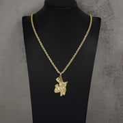 Polished 10k gold Pillsbury Doughboy pendant hanging on a rope chain, displayed on a bust.