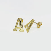 Pair of gold diamond-cut initial letter 'A' stud earrings on a white background.