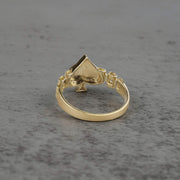 10k gold ring with a Spade design back view on a gray surface
