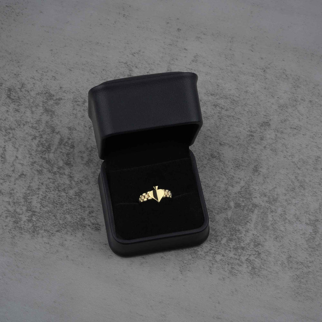 sleek classic 10K gold spade ring on a black jewelry box front view