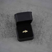 sleek classic 10K gold spade ring on a black jewelry box front view