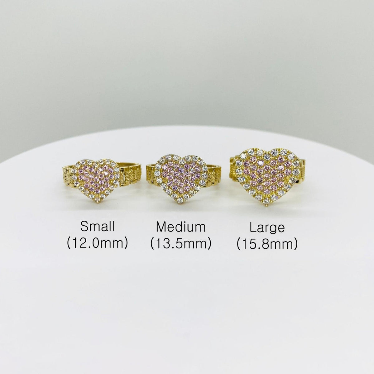 Three pink sparkle heart-shaped rings in small, medium, and large sizes 