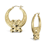 A pair of 10k yellow gold teddy bear-shaped hoop earrings with diamond-cut, textured finishes.