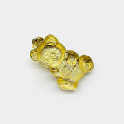 Back view of 10k gold teddy bear pendant showing openwork hollow pattern and 10k stamp.