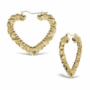 Two twisted 10k yellow gold heart-shaped hoop earrings against a clean white background.