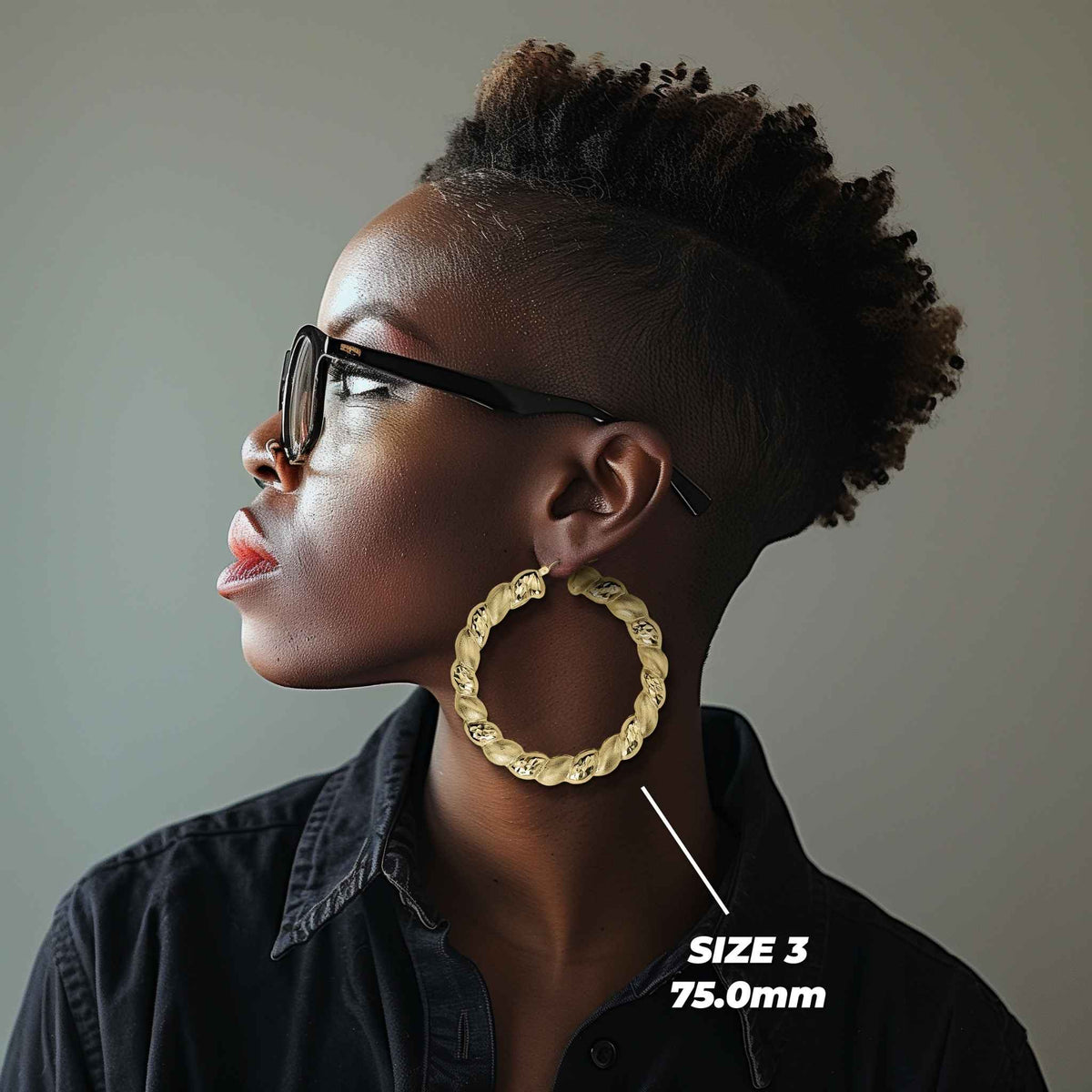 Side profile of a woman wearing 75mm 10k gold twisted round hoop earrings.