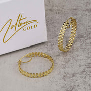 Pair of 10k gold rollie hoop earrings showcased with Nolters Gold packaging.