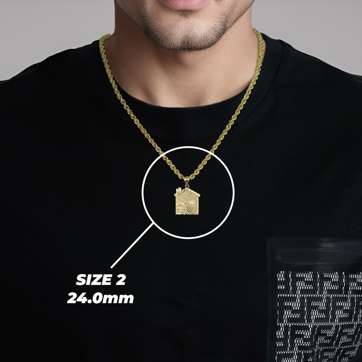 Model wearing a gold trap house pendant with Size 2 24.0mm label.