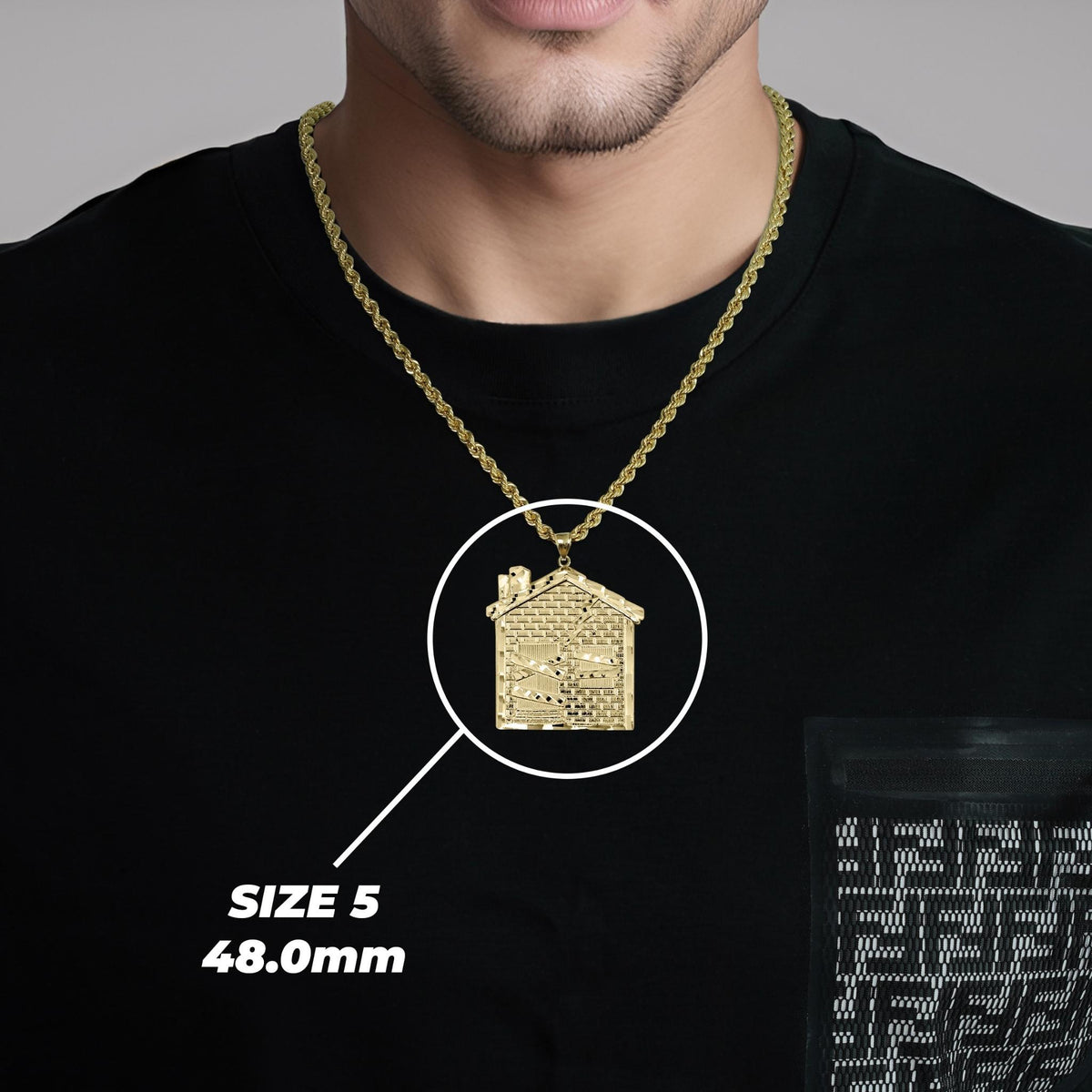 Model wearing a gold trap house pendant with Size 5 48.0mm label.