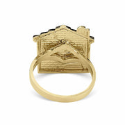 Back view of a 10k gold trap house signet ring on a white background.