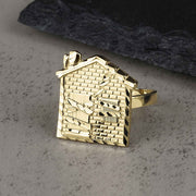10k yellow gold ring featuring a detailed house design with diamond-cut brick patterns.