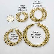 10k gold twisted hoop earrings in multiple sizes 35mm, 45mm, 50mm, 80mm with a quarter.