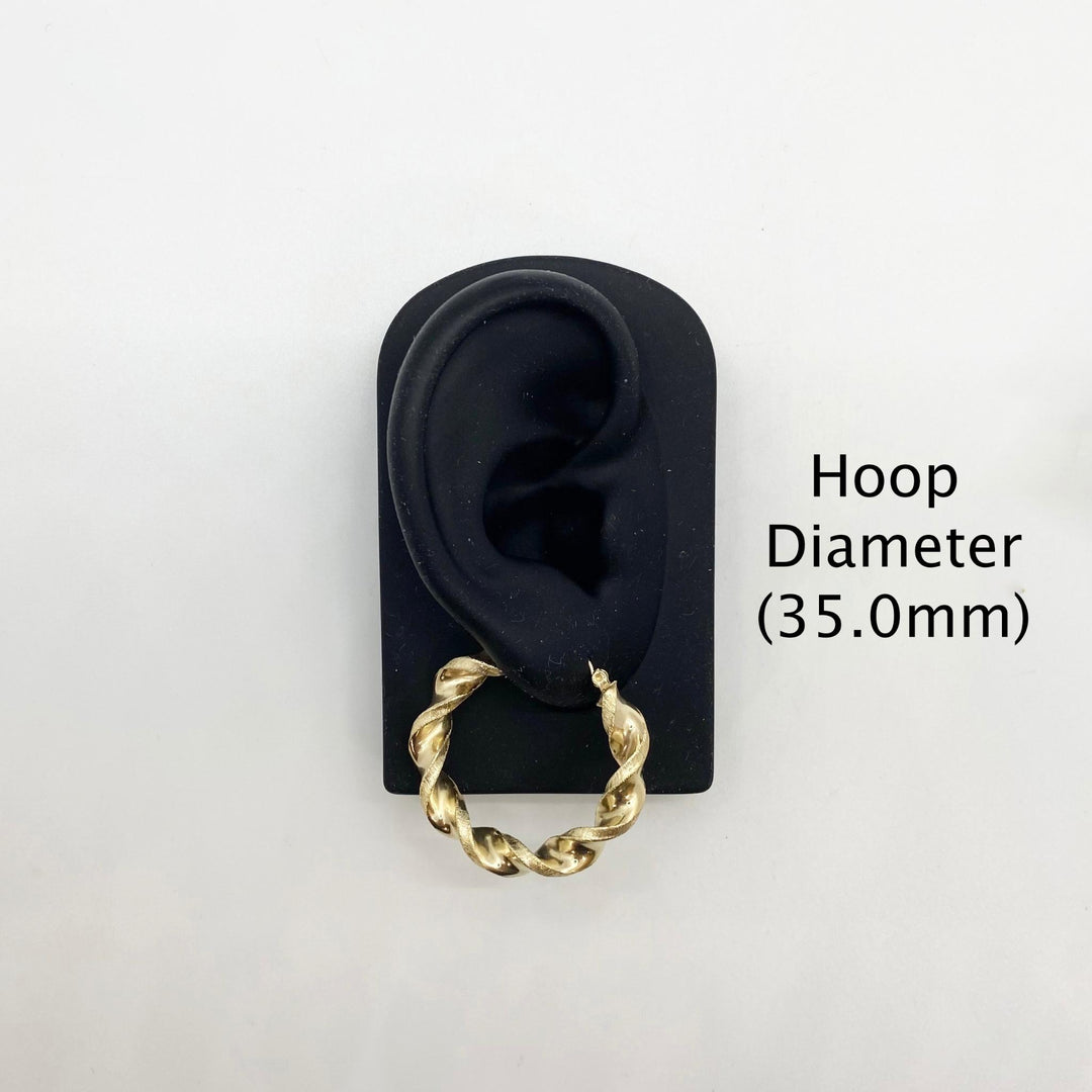 35.0mm 10k gold twisted hoop earring on a black display stand.
