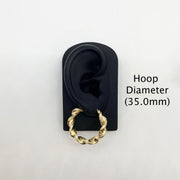 35.0mm 10k gold twisted hoop earring on a black display stand.
