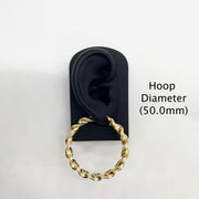 50.0mm 10k gold twisted hoop earring on a black display stand.