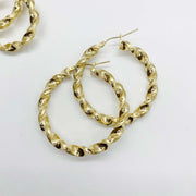 Pair of 10k yellow gold twisted round hoop earrings on a clean white background.