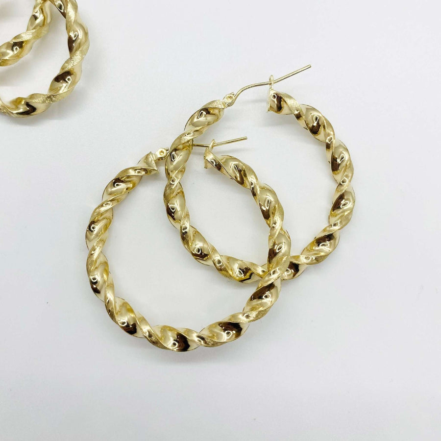 Pair of 10k yellow gold twisted round hoop earrings on a clean white background.